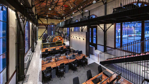 A new mezzanine level adds daylight workspace and defines the main entryway,