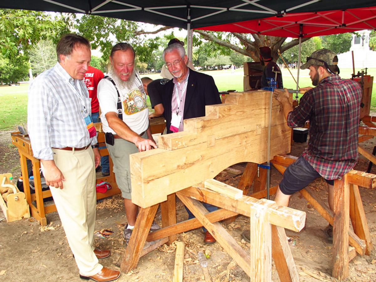 Ron Staley (left), of The Christman Company, a sponsor of the cannon carriage workshop, and David Woodcock (right), former president of APT, join me in appreciating the workmanship of the students.