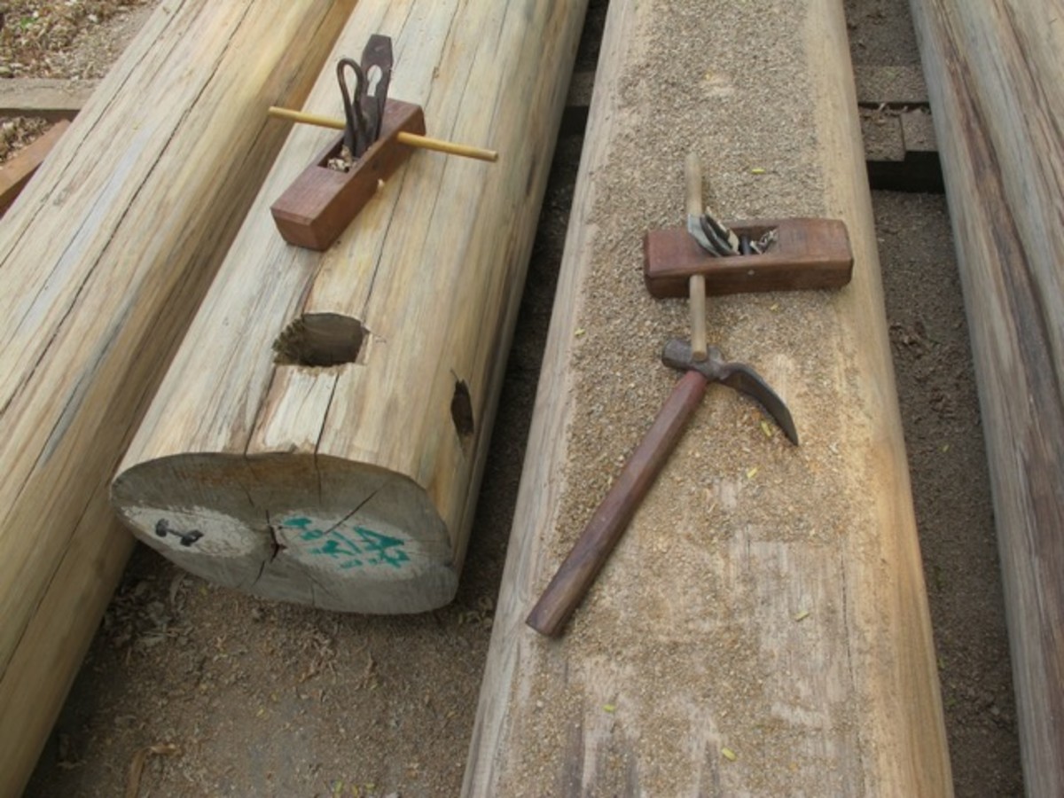 Traditional carpenters tools in Myanmar. The holes in the log are for chains that the elephants use to skid the logs out of the forest.