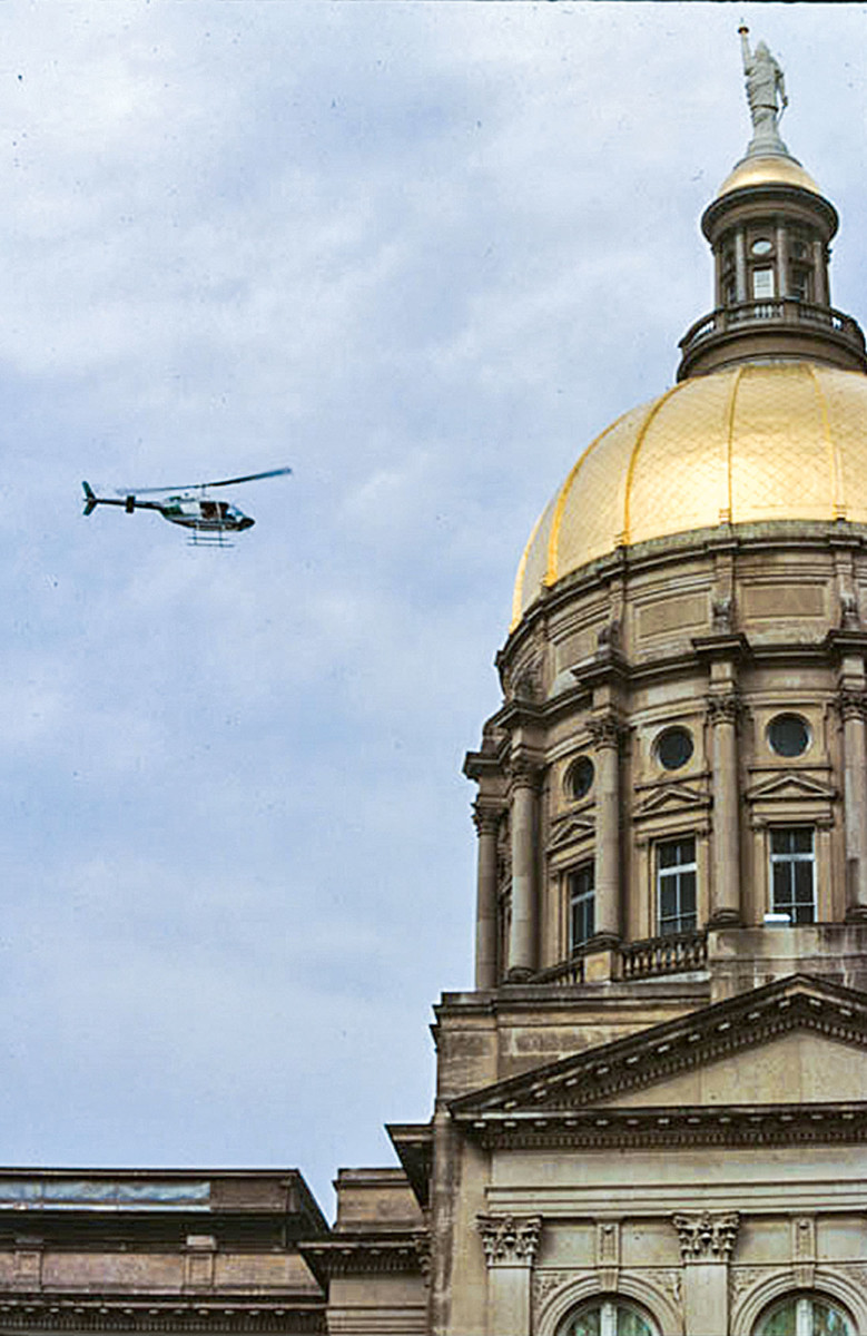 helicopter flying around Georgia's State Capitol's dome