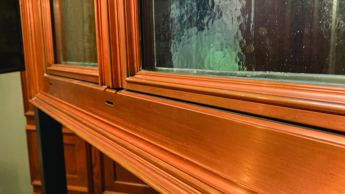 A mock-up demonstrates the sophisticated sash profiles possible with copper. Though readily shaped, the metal in sheets is soft so Mixlegno Group has perfected methods for extruding it in 2mm-thick members for window construction that can be combined with desirable woods such as oak.