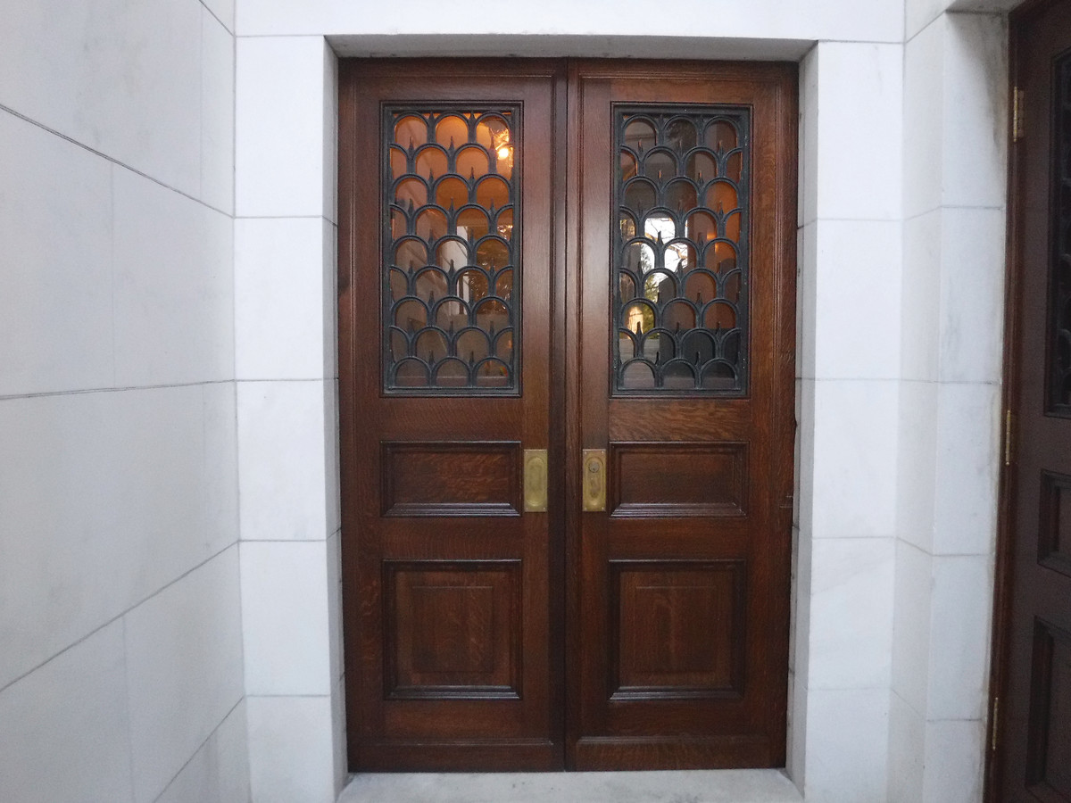 One type of pocket door after restoration. Each door weighs some 80 lbs. minus operable sash and bronze grates, making repeated hangings and adjustments physically demanding.