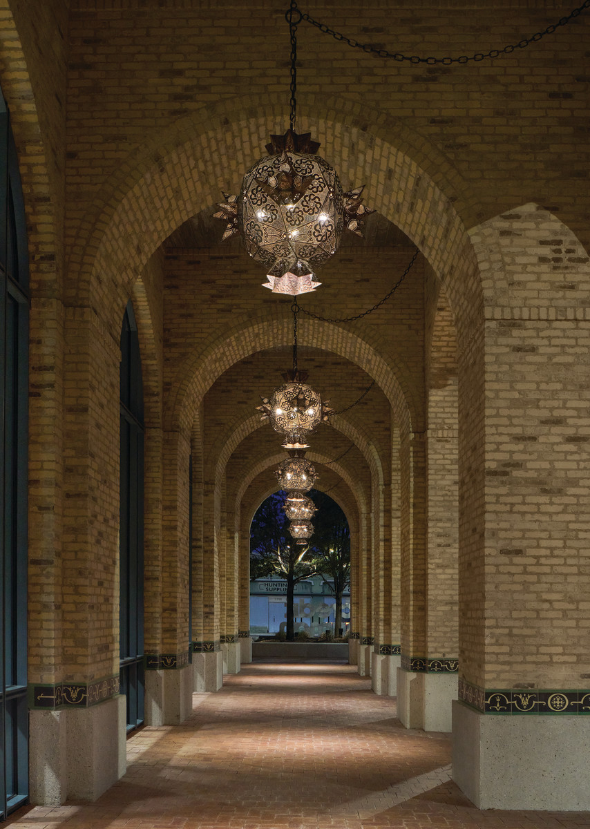 The street-level pedestrian way was designed to be engaging. In lieu of sidewalks, an arched allee with thick brick columns makes for a rich architectural experience.