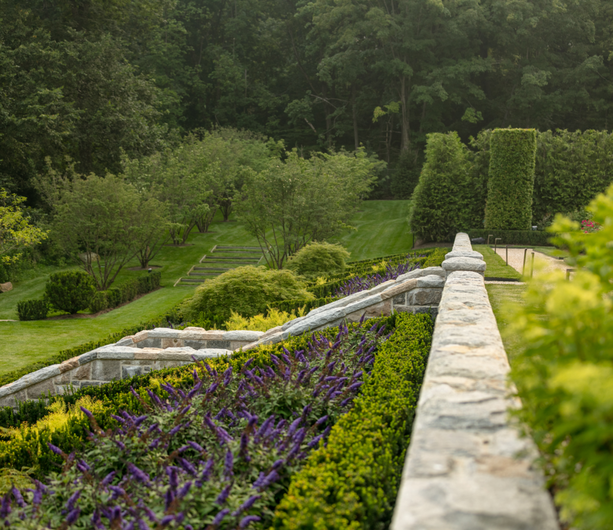 Designed by Janice Parker Landscape Architects, the lower parterres of Rose Manor in Connecticut are planted with buddleia, taxus, and spirea, with a weeping maple specimen tree at the central point of each design.