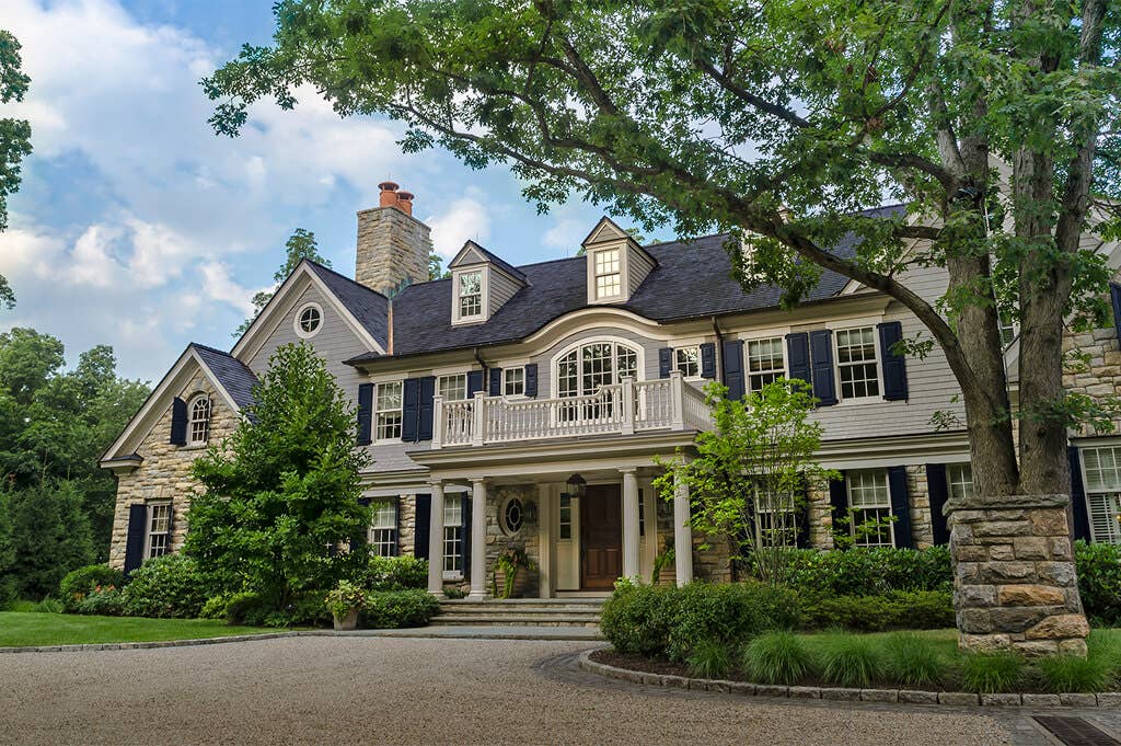 timberlane-gallery-blue-panel-shutters-gray-siding-house-angled.jpg