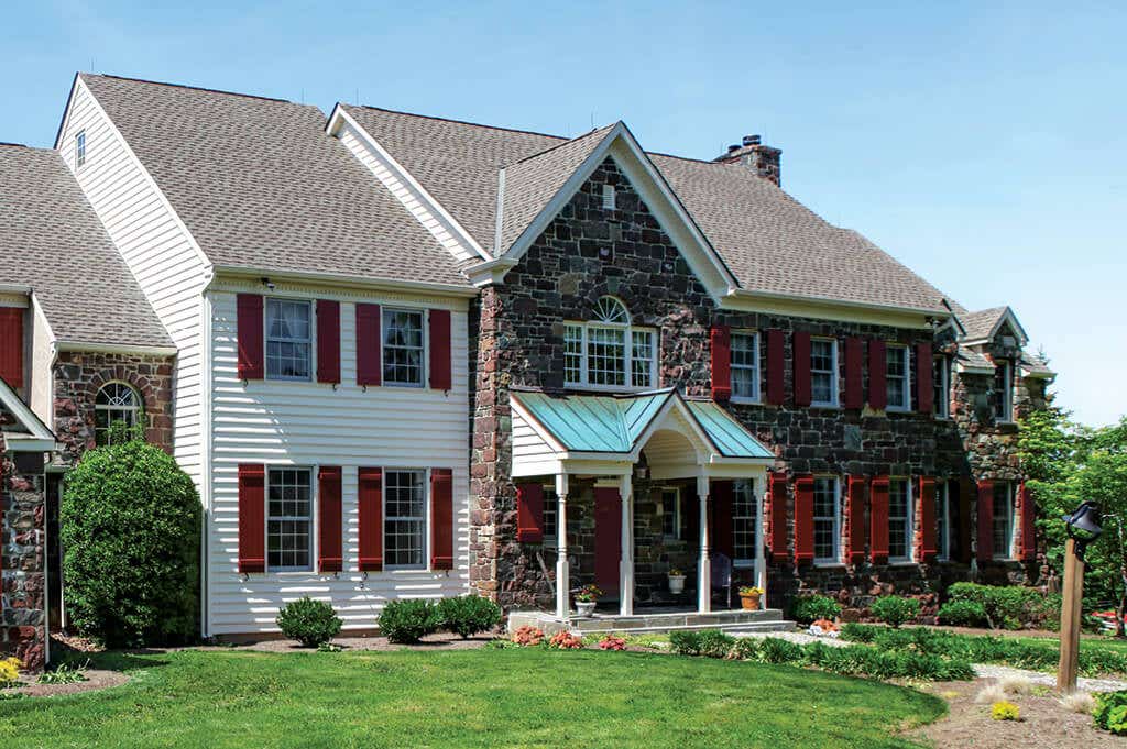 timberlane-gallery-red-board-batten-shutters-red-stone-white-siding-house.jpg